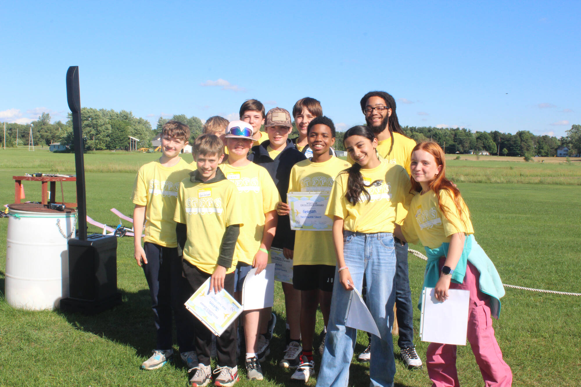 Group of middle school students hold the certificates they earned at STEPS camp